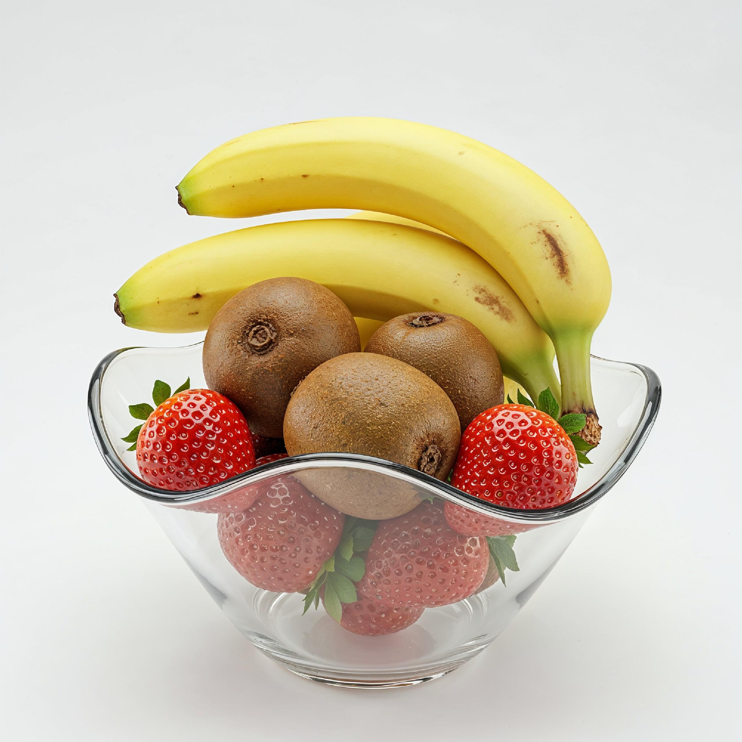 Fresh Fruit Arrangement in Glass Bowl with Bananas, Kiwi and Strawberries on White Background