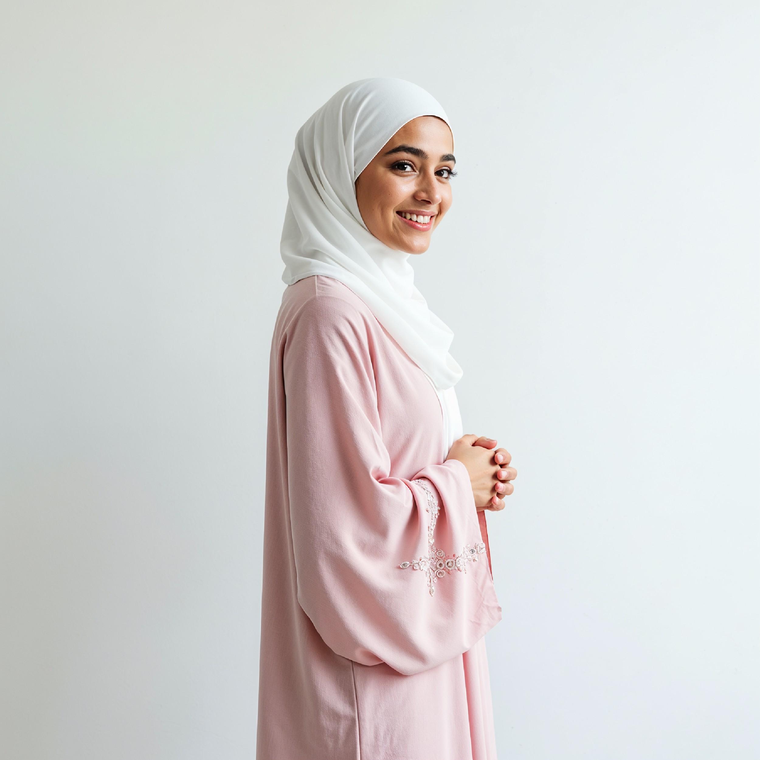 Beautiful Young Muslim Woman Wearing White Hijab and Modest Dress in Studio Portrait