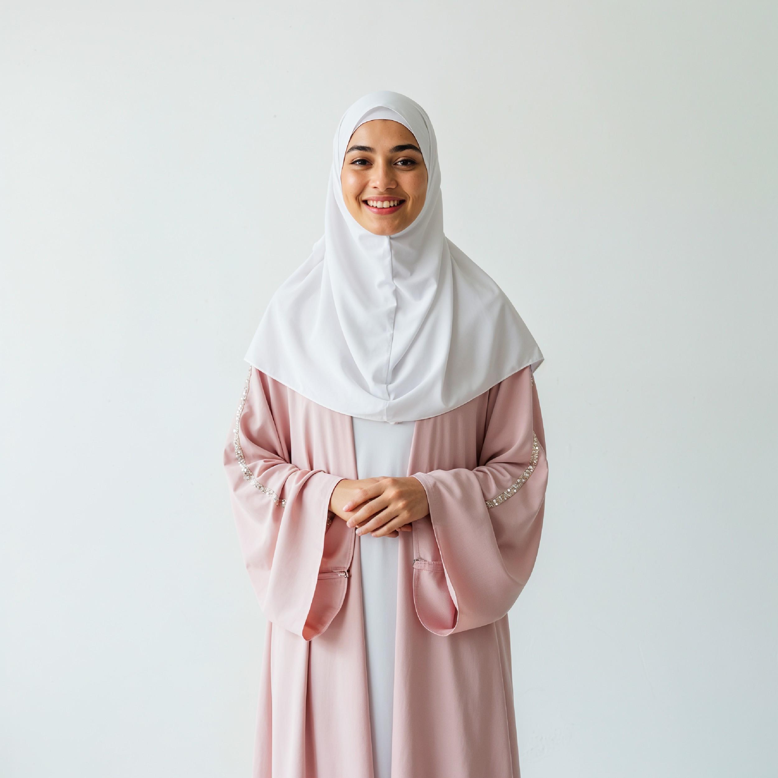 Beautiful Young Muslim Woman Wearing White Hijab and Modest Dress in Studio Portrait