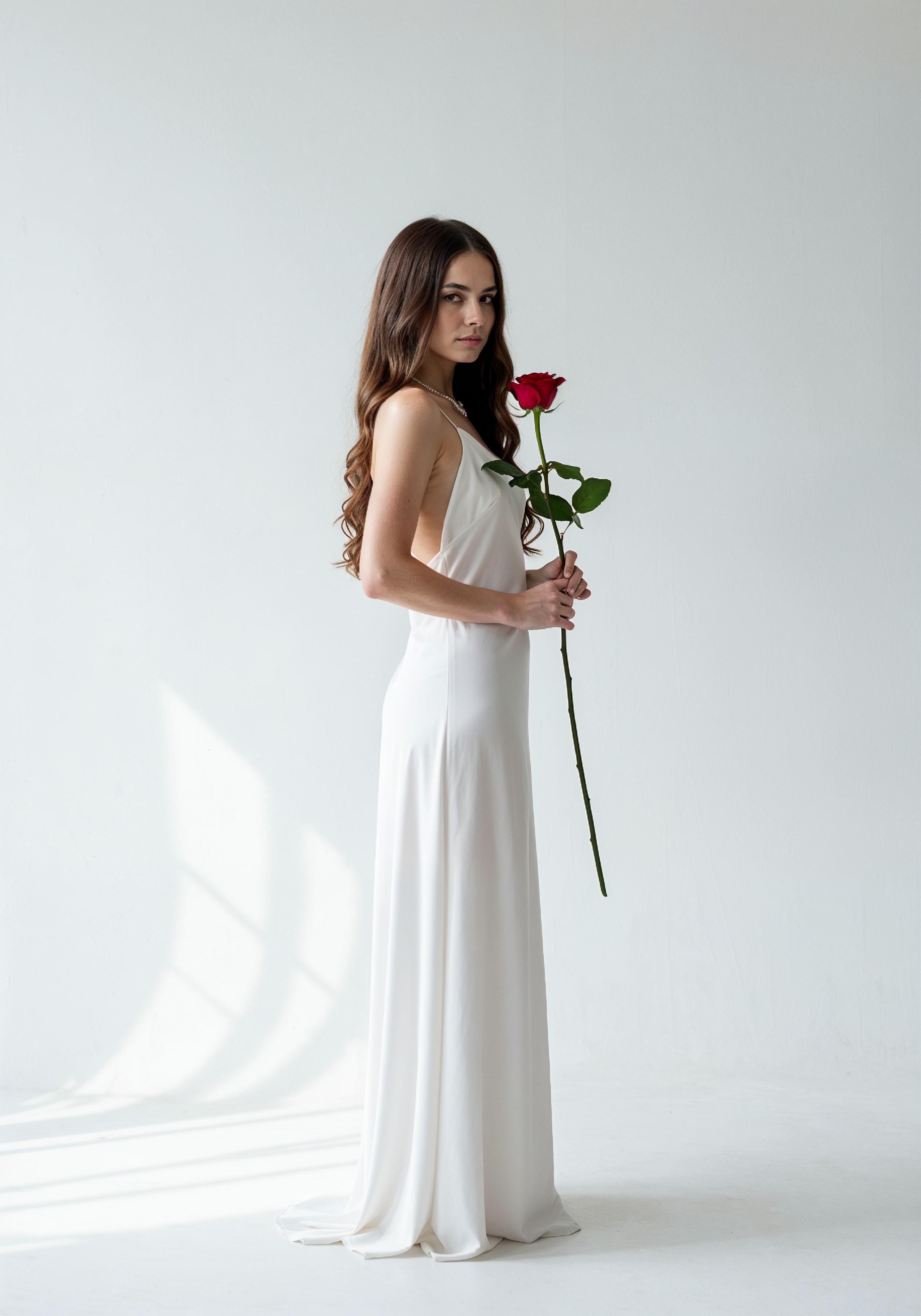 Beautiful Young Woman Holding Red Rose in Elegant Dress Romantic Portrait