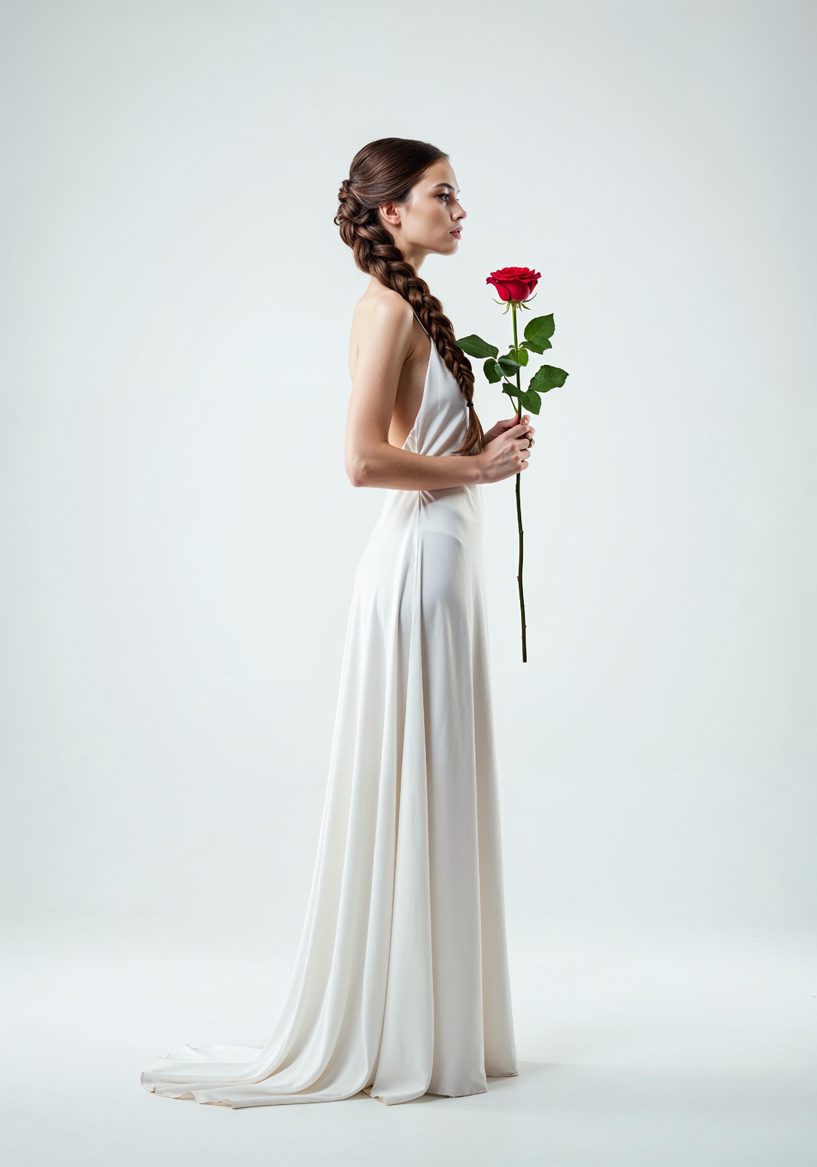 Beautiful Young Woman Holding Red Rose in Elegant Dress Romantic Portrait