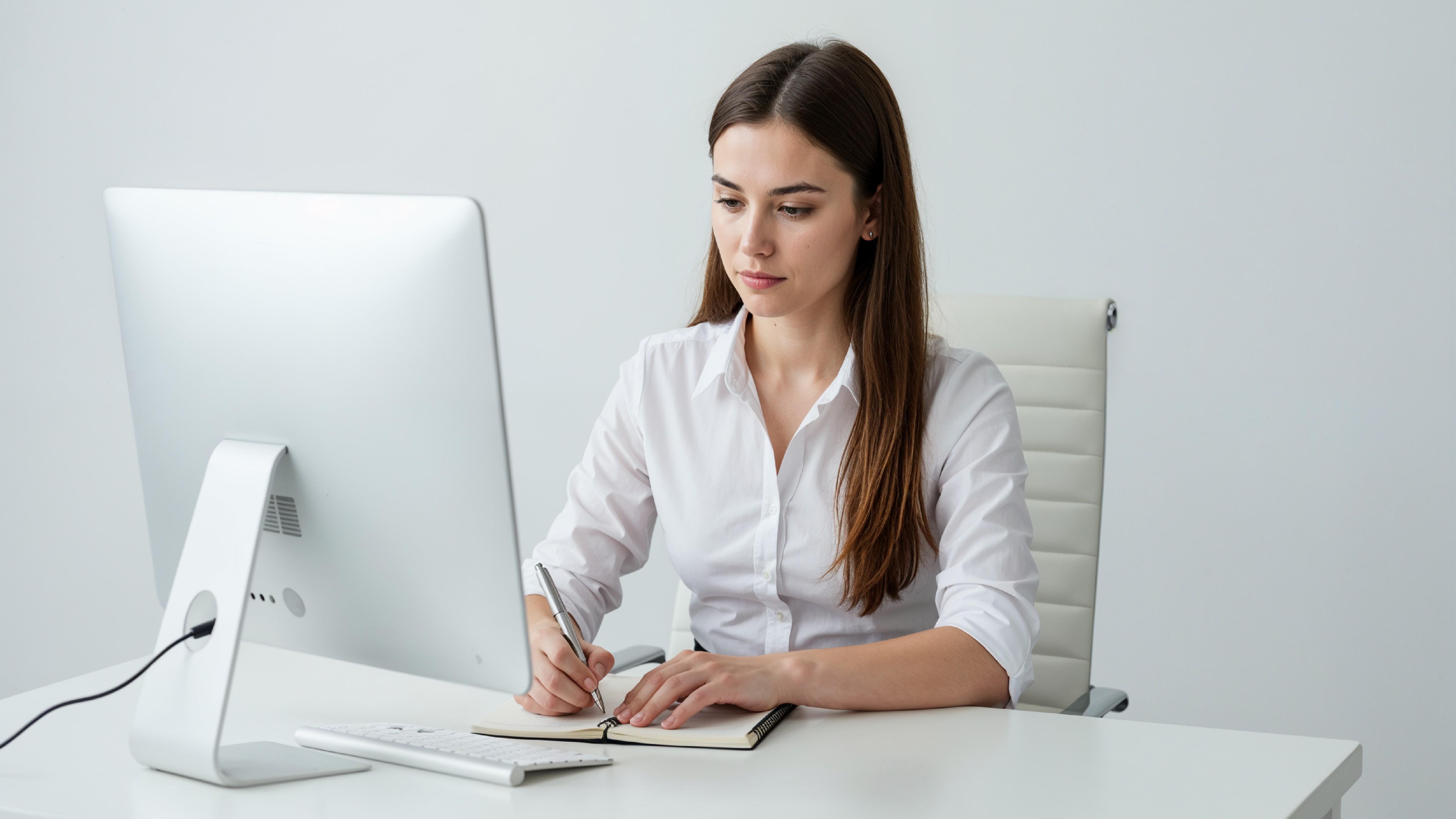 Beautiful Young Woman Working on Laptop at Modern Office Desk, Professional Business Portrait