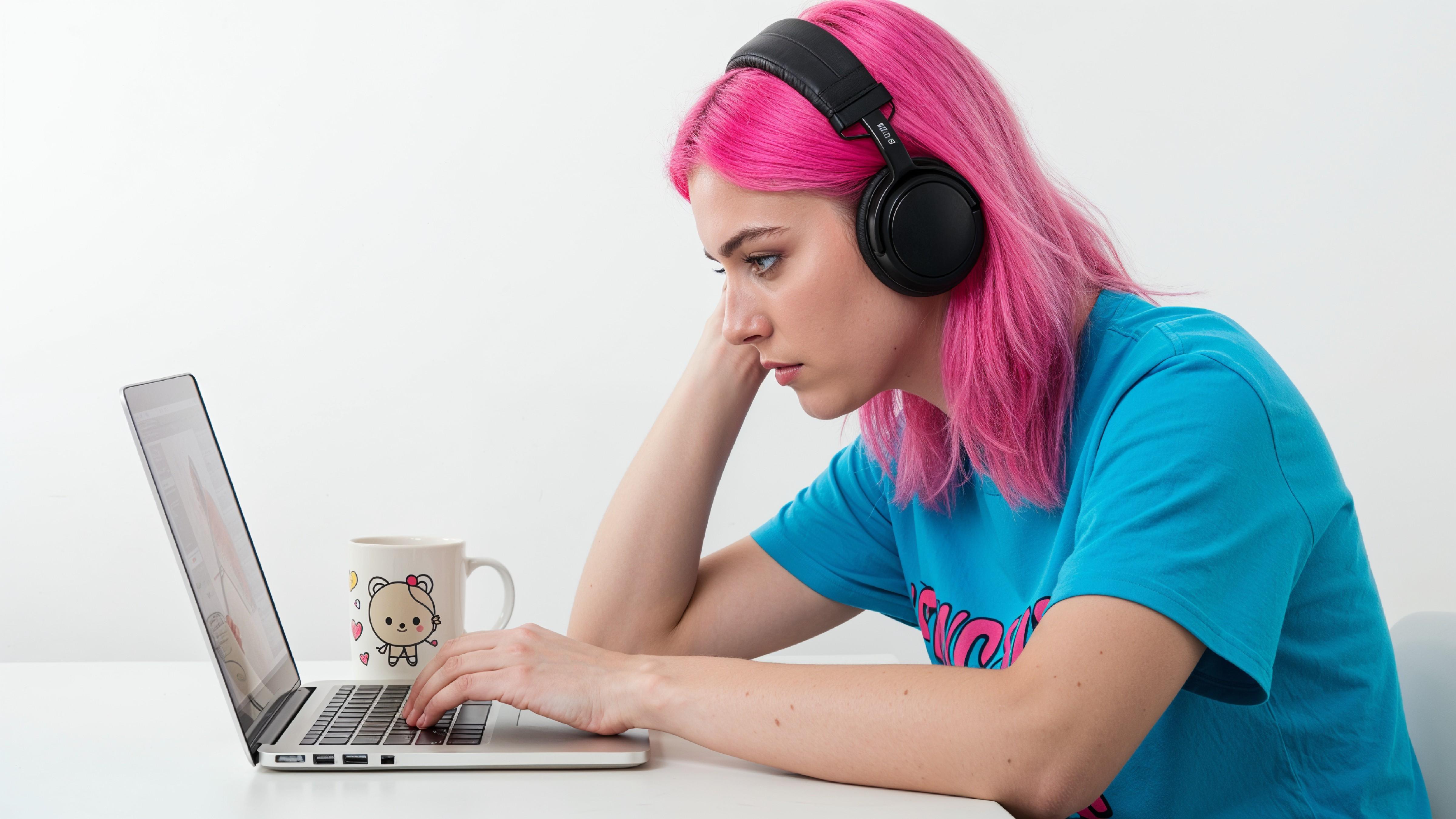 Beautiful Young Woman Working on Laptop at Modern Office Desk, Professional Business Portrait