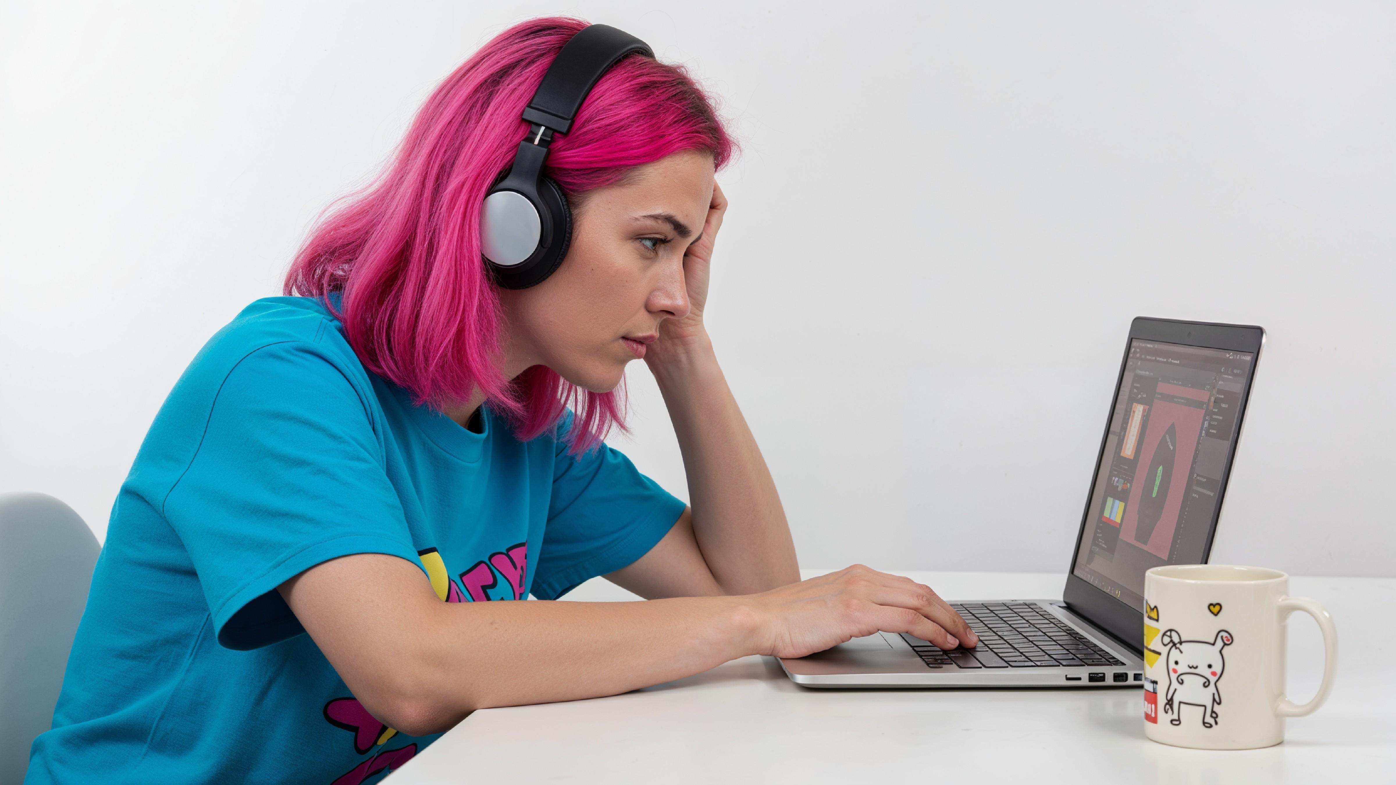 Beautiful Young Woman Working on Laptop at Modern Office Desk, Professional Business Portrait