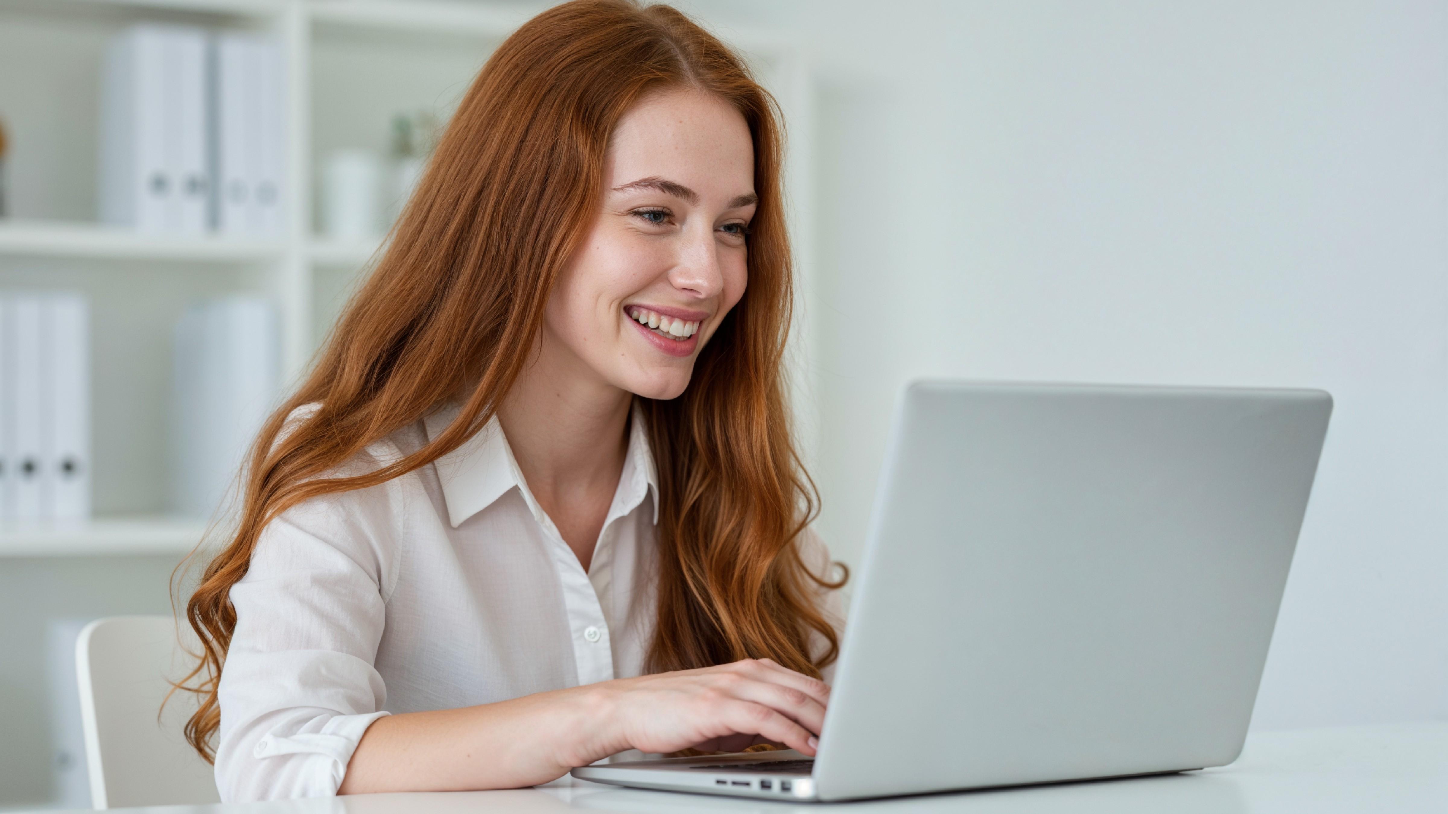 Beautiful Young Woman Working on Laptop at Modern Office Desk, Professional Business Portrait
