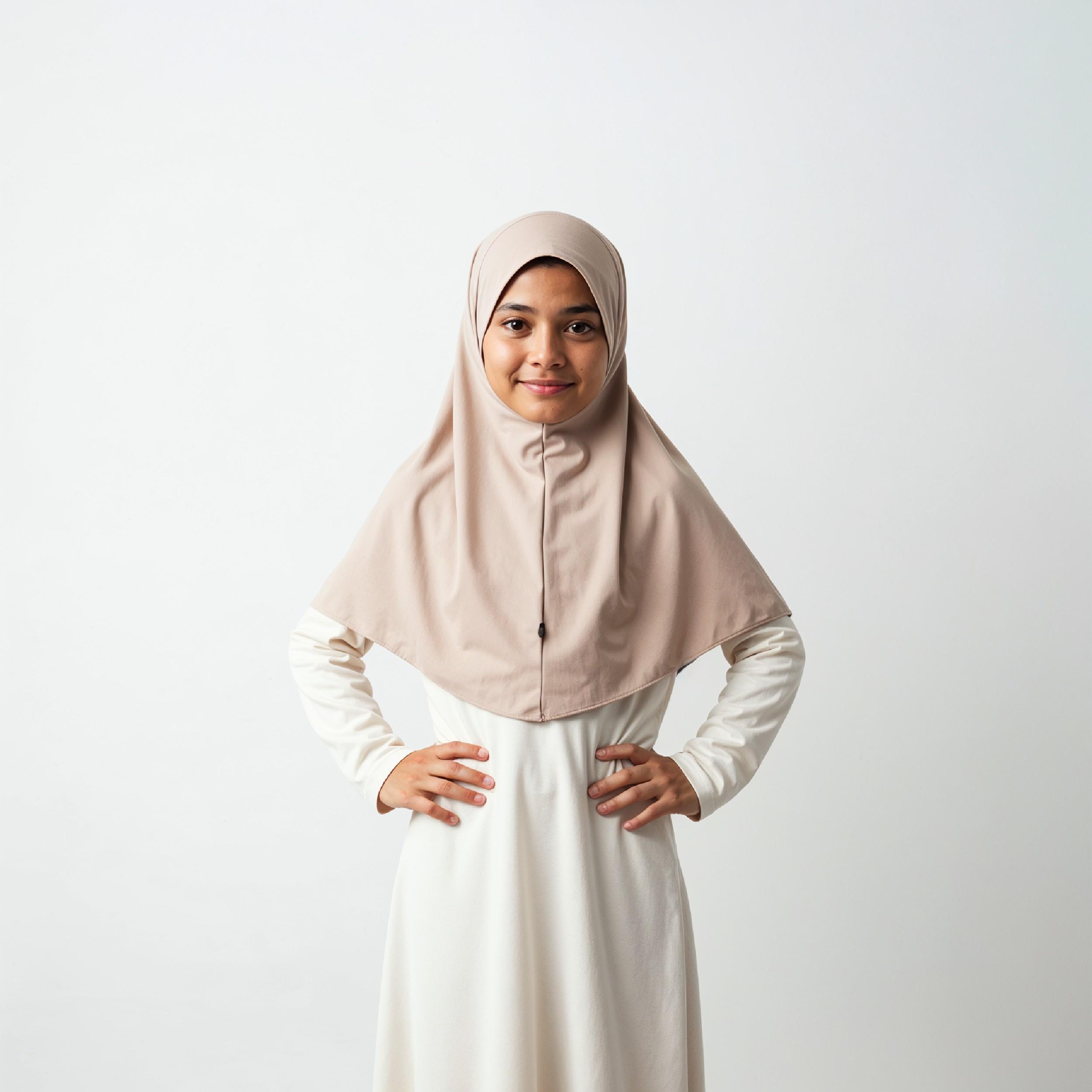 Cute Young Muslim Girl Wearing Beige Hijab and Modest Dress in Studio Portrait