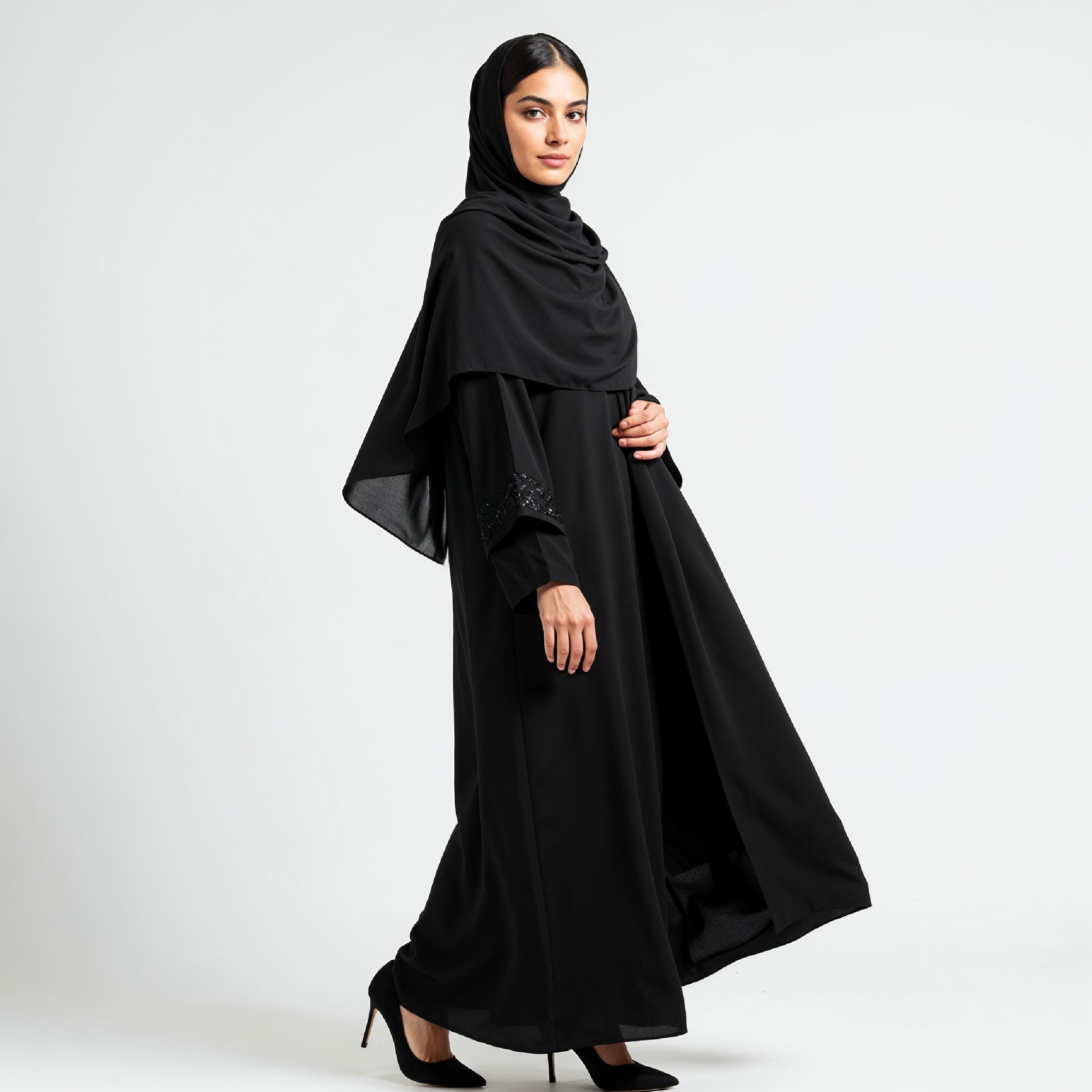 Elegant Muslim Woman Wearing Black Hijab and Abaya in Studio Portrait on Light Background