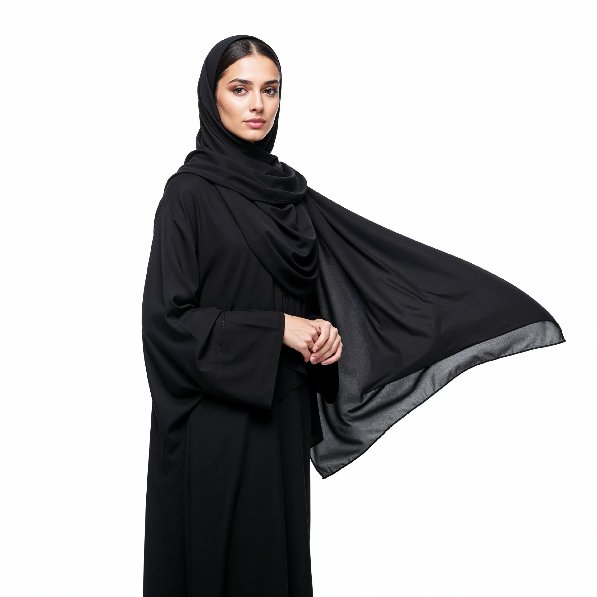 Elegant Muslim Woman Wearing Black Hijab and Abaya in Studio Portrait on Light Background