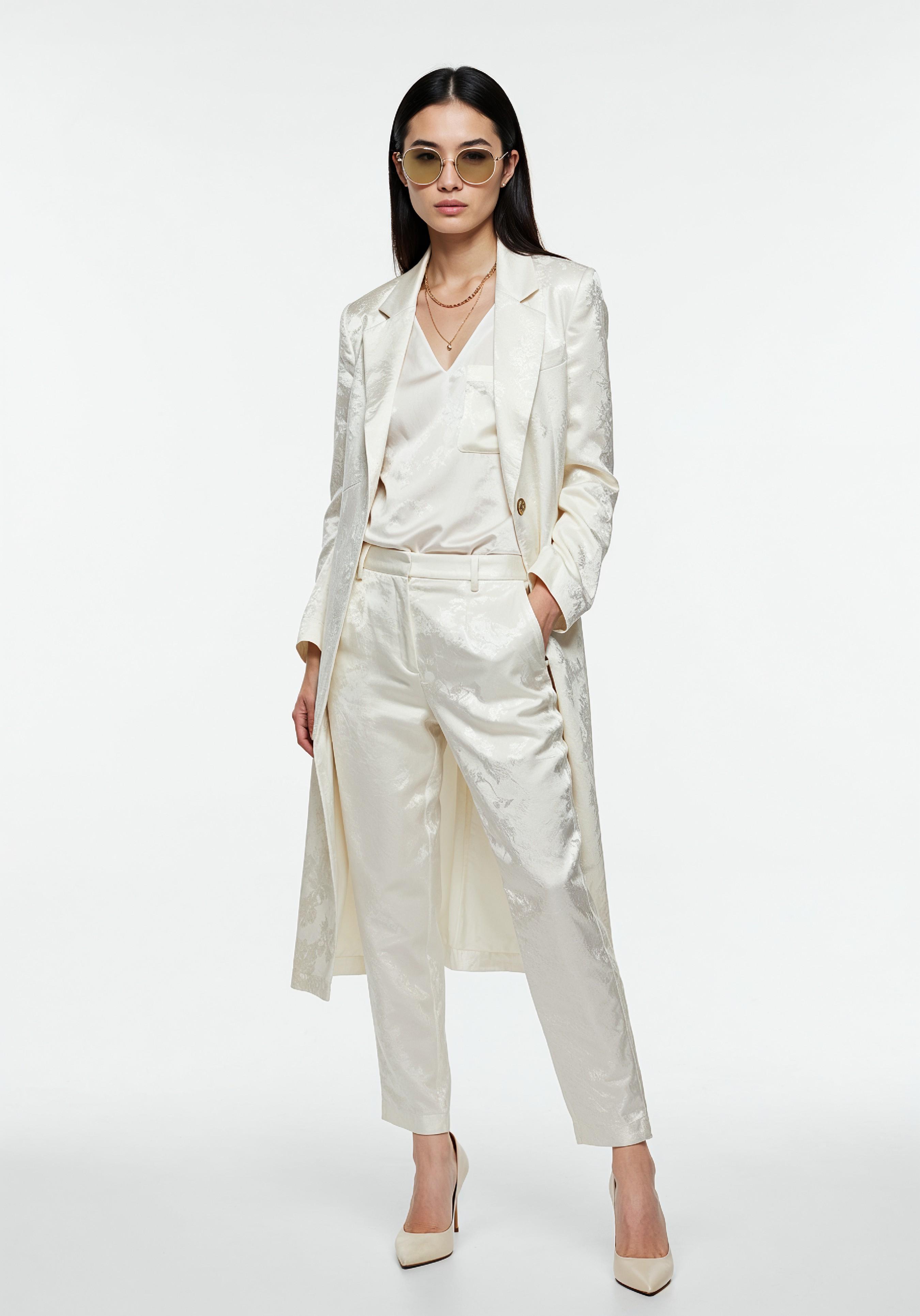 Elegant Young Woman in Coat and Matching Trousers Fashion Portrait