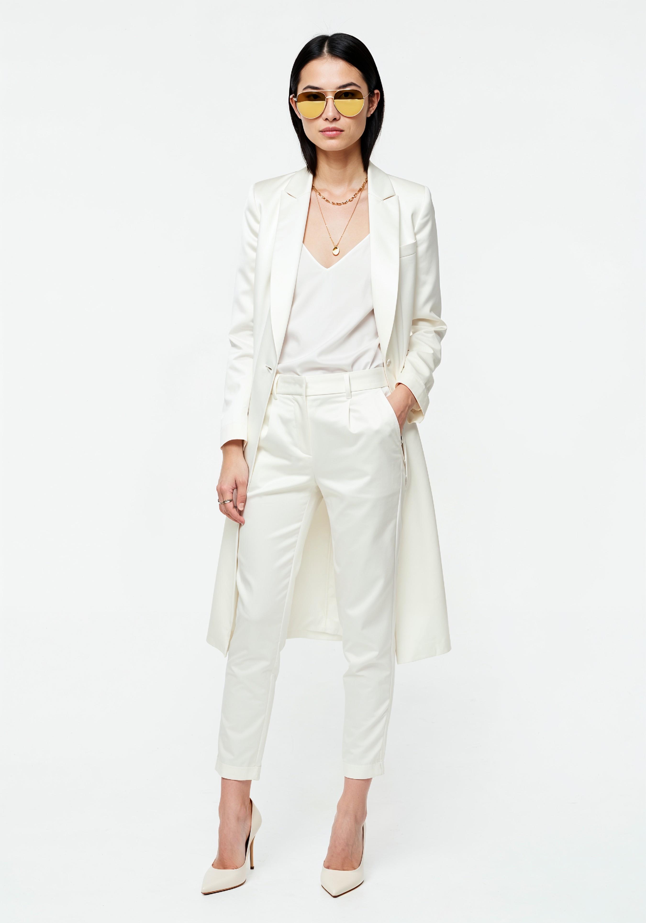Elegant Young Woman in Coat and Matching Trousers Fashion Portrait
