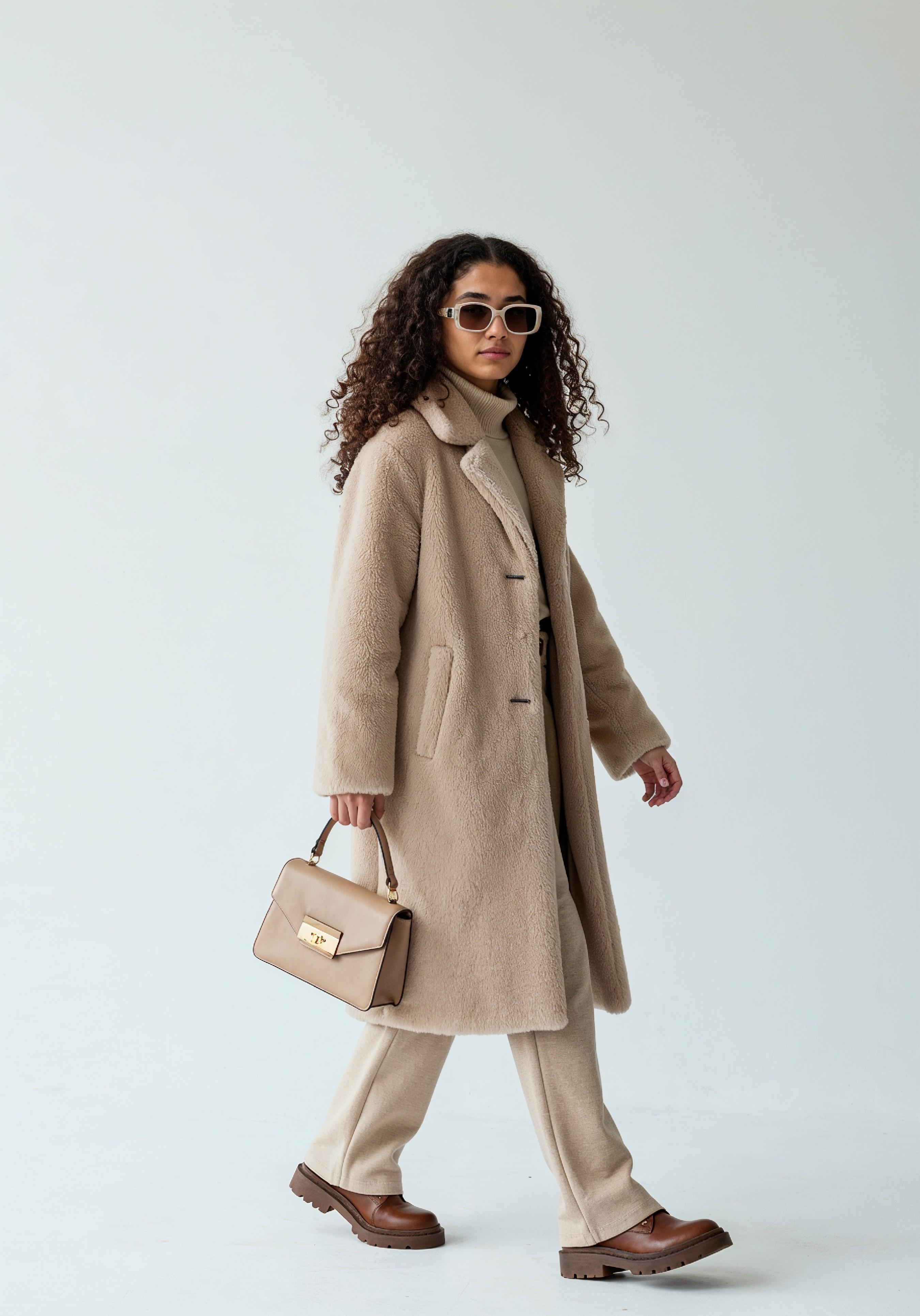Elegant Young Woman in Coat and Matching Trousers Fashion Portrait