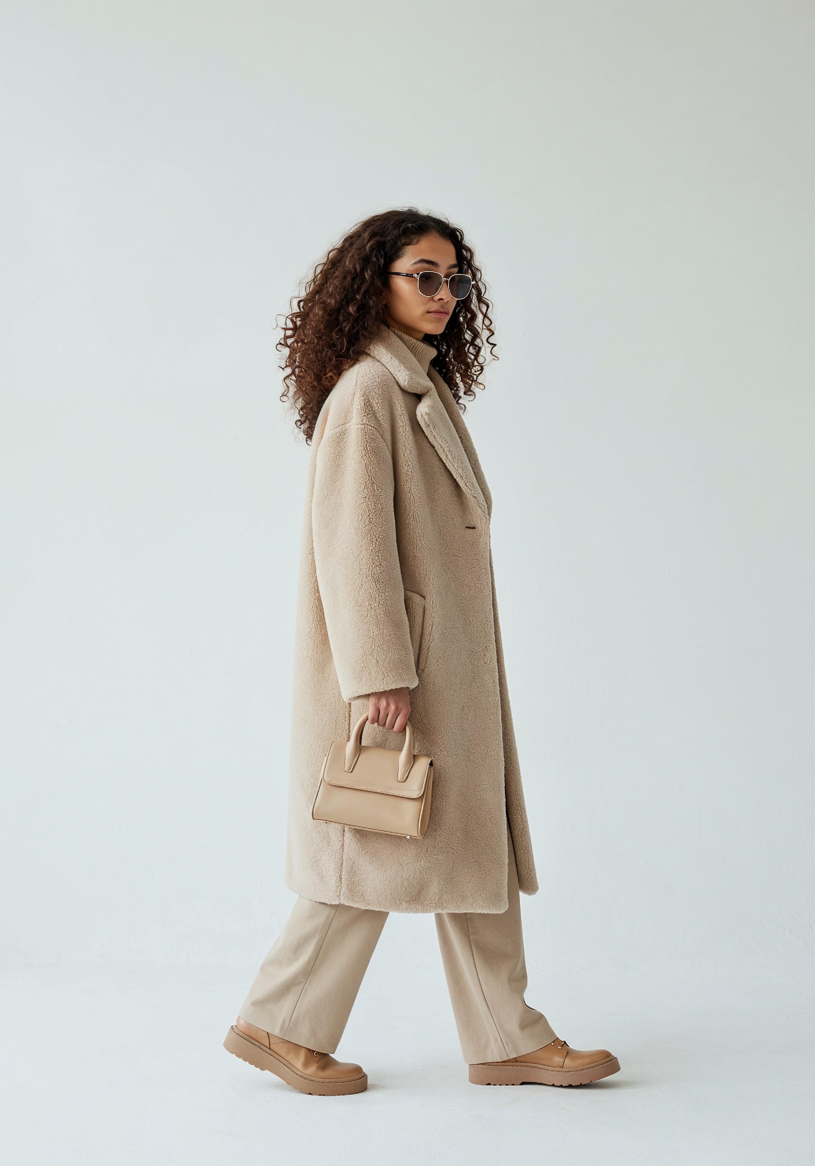 Elegant Young Woman in Coat and Matching Trousers Fashion Portrait