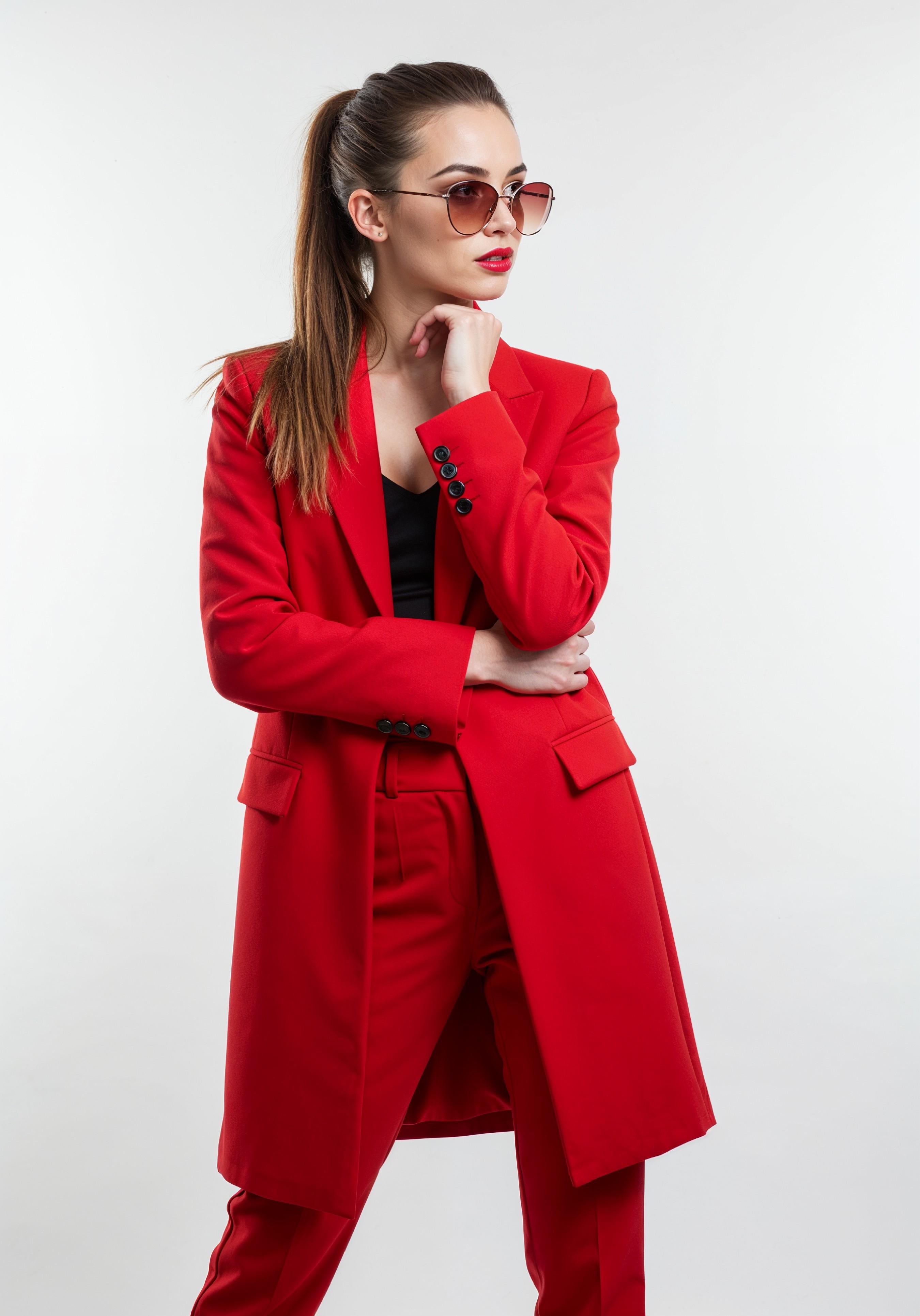 Elegant Young Woman in Coat and Matching Trousers Fashion Portrait