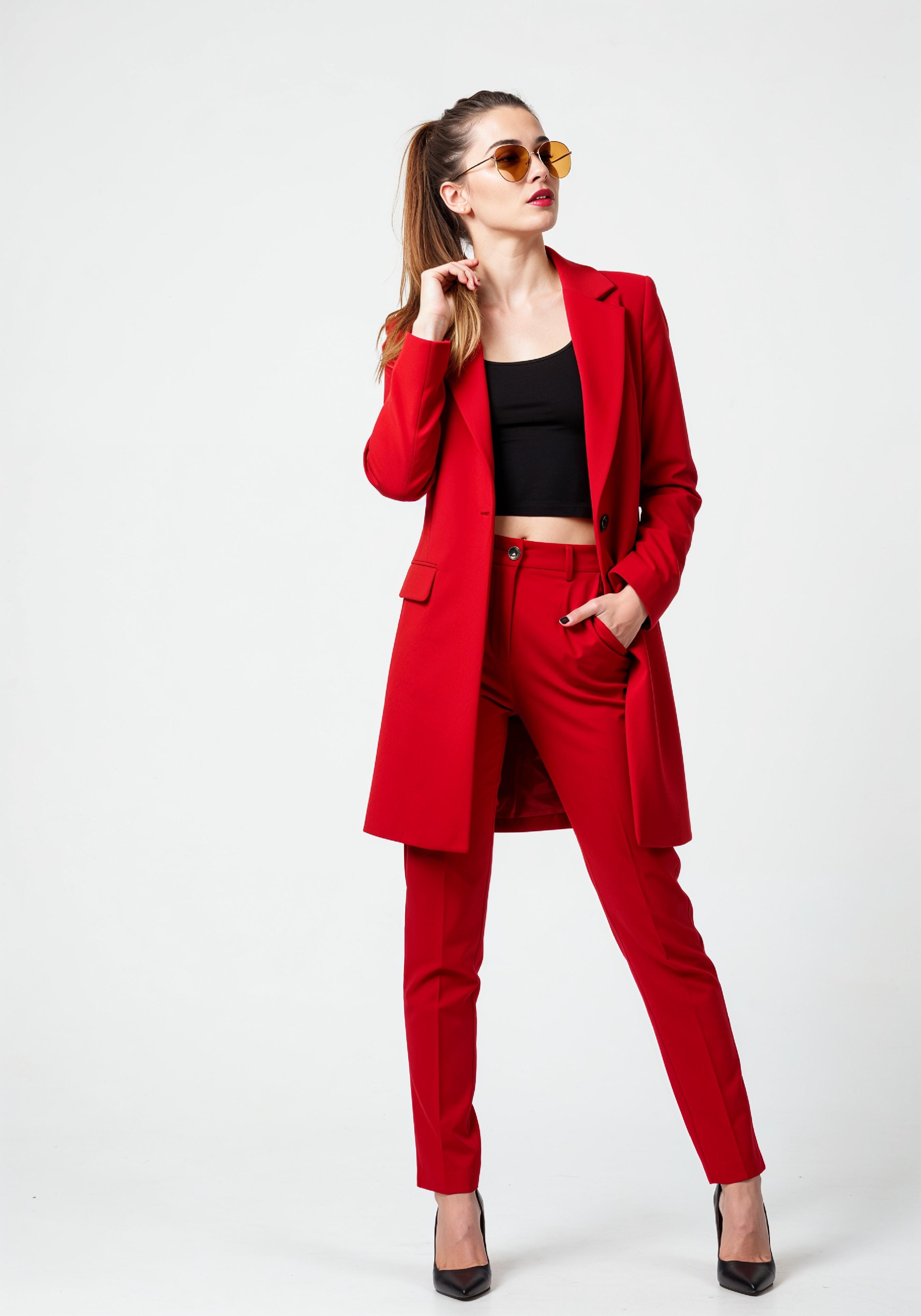 Elegant Young Woman in Coat and Matching Trousers Fashion Portrait