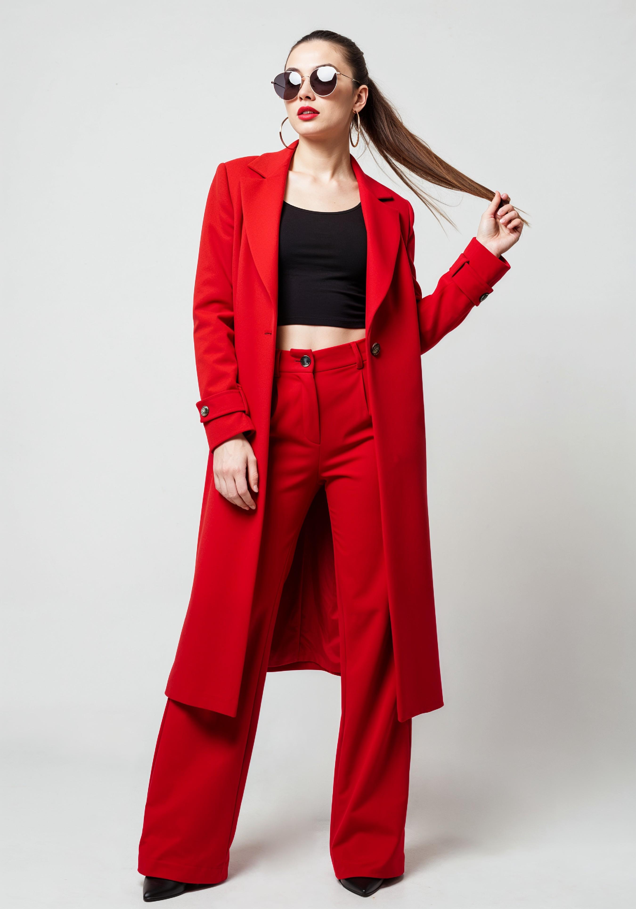 Elegant Young Woman in Coat and Matching Trousers Fashion Portrait