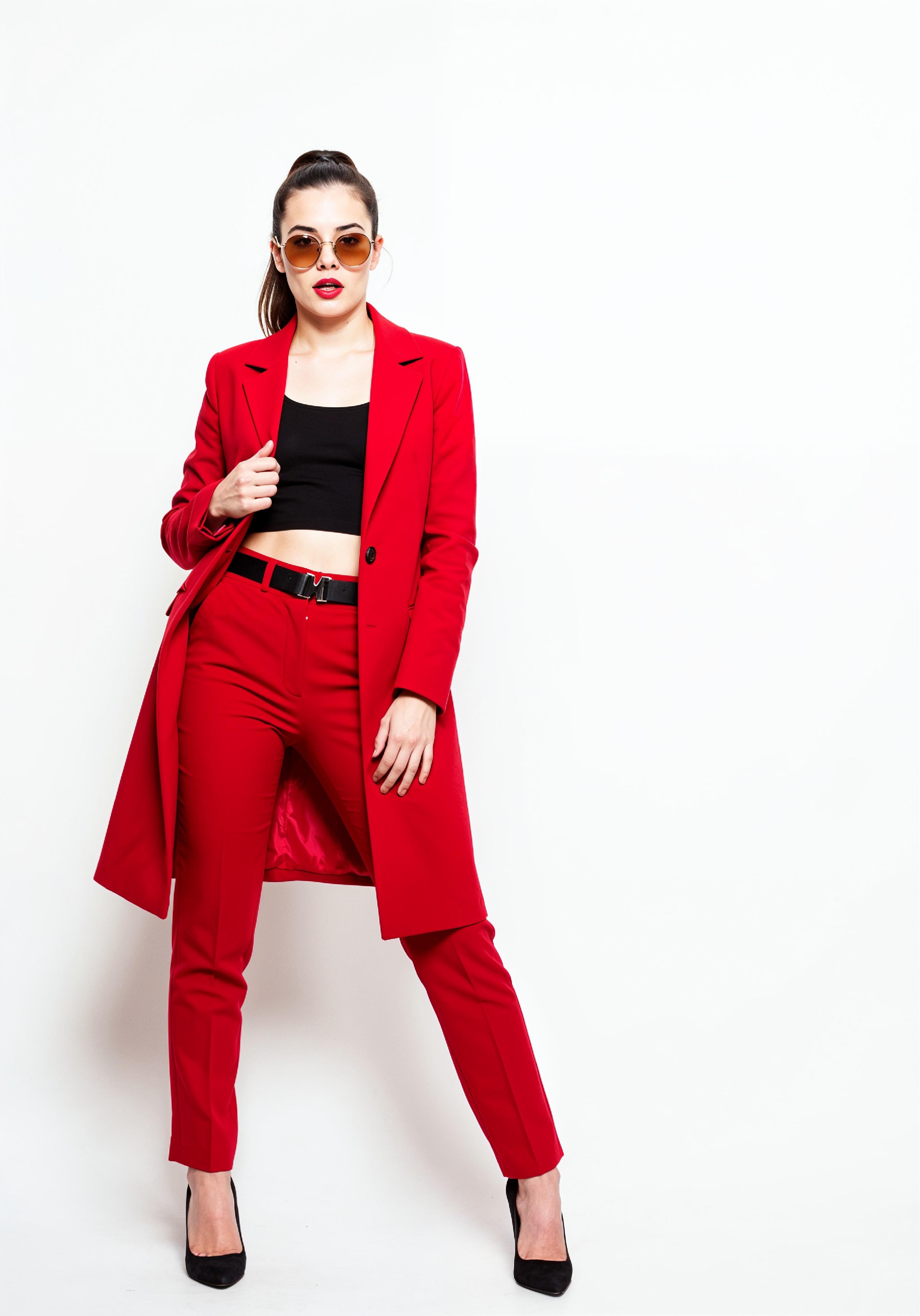 Elegant Young Woman in Coat and Matching Trousers Fashion Portrait