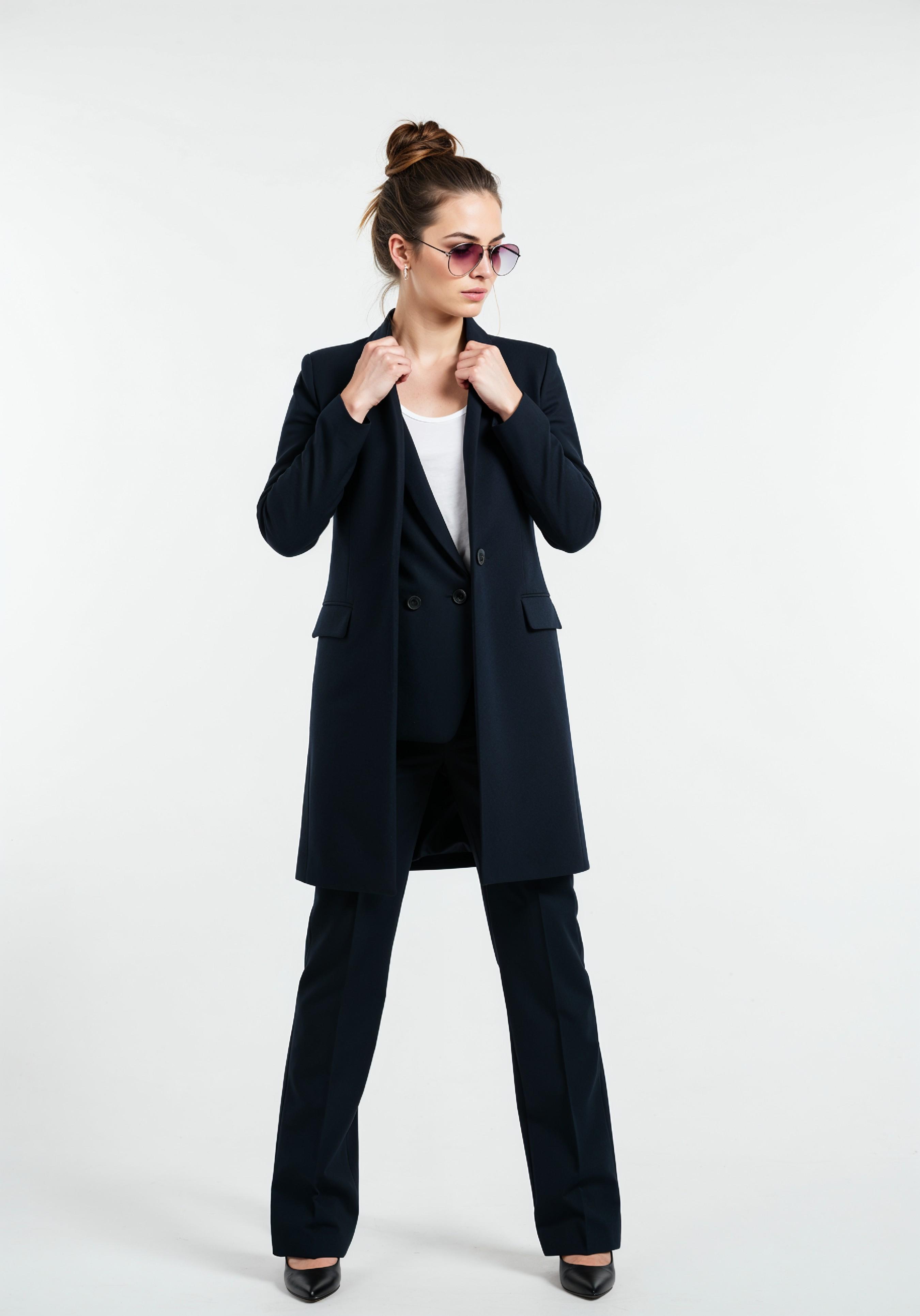 Elegant Young Woman in Coat and Matching Trousers Fashion Portrait