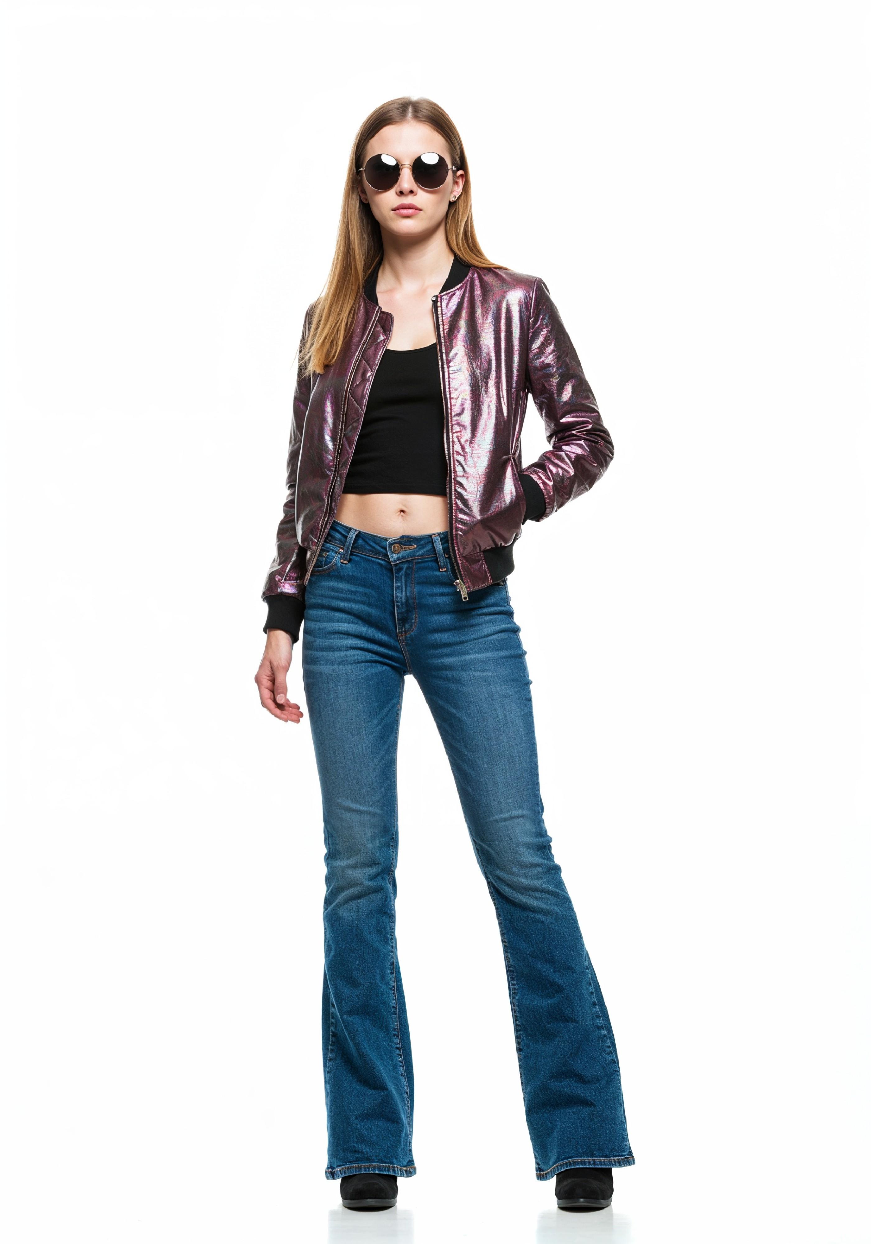 Fashionable Young Woman in Metallic Bomber Jacket and Flared Jeans Street Style Portrait