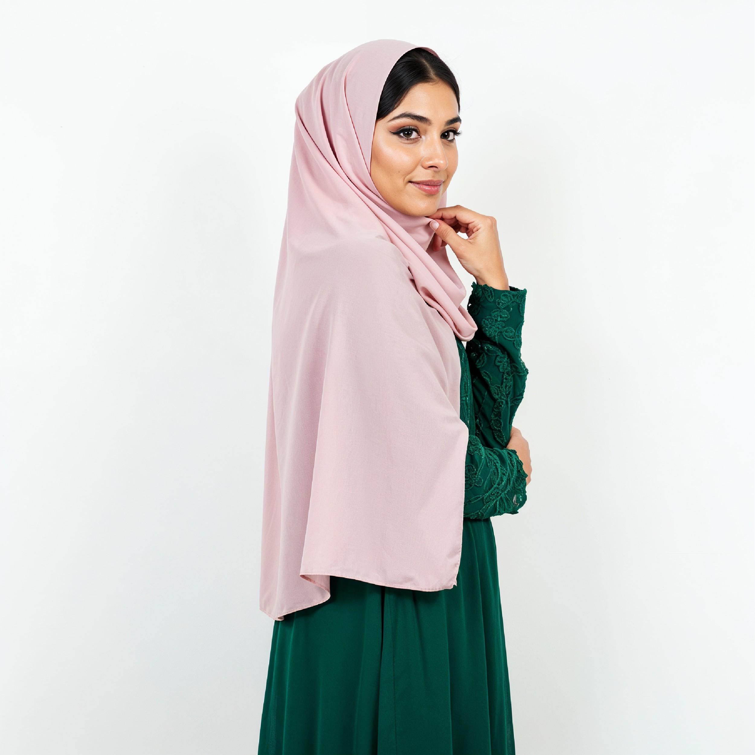 Graceful Young Muslim Woman Wearing Pastel Hijab and Elegant Modest Dress in Studio Portrait
