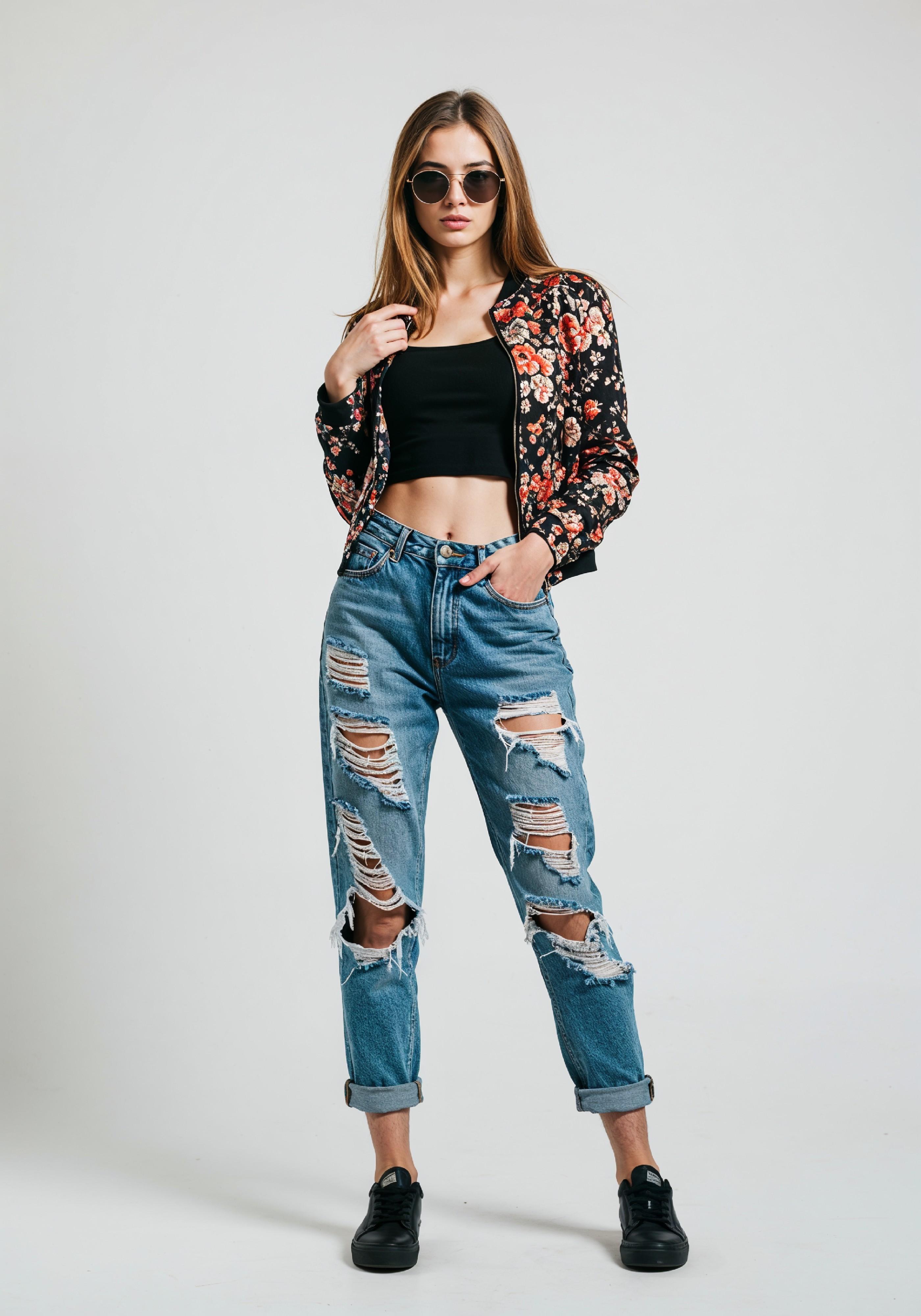 Stylish Young Woman in Floral Jacket and Ripped Jeans Trendy Street Fashion Portrait
