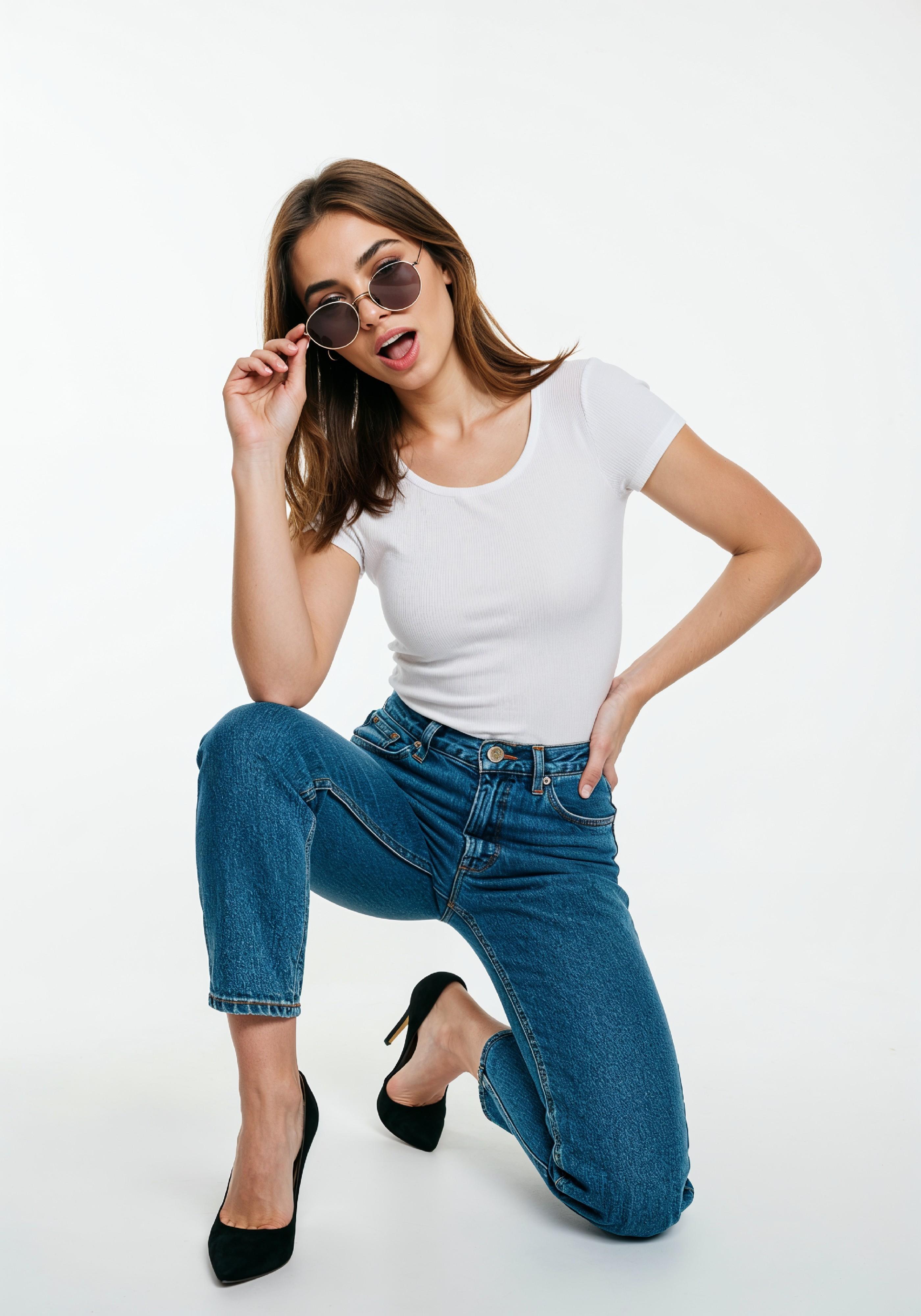 Stylish Young Woman in High Waist Jeans and White T Shirt Casual Fashion Portrait