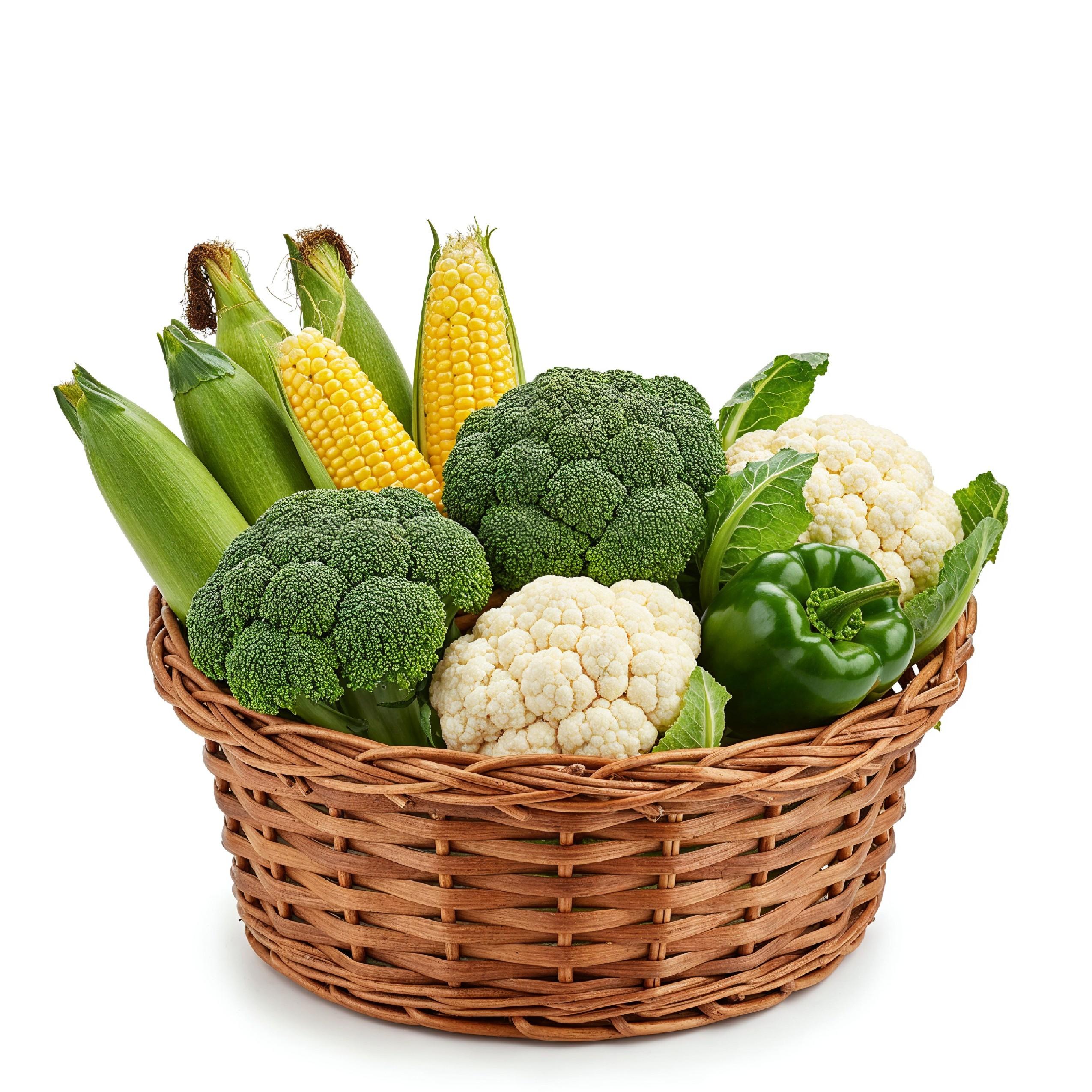 Fresh Seasonal Vegetables in Round Wicker Basket Isolated on White Background