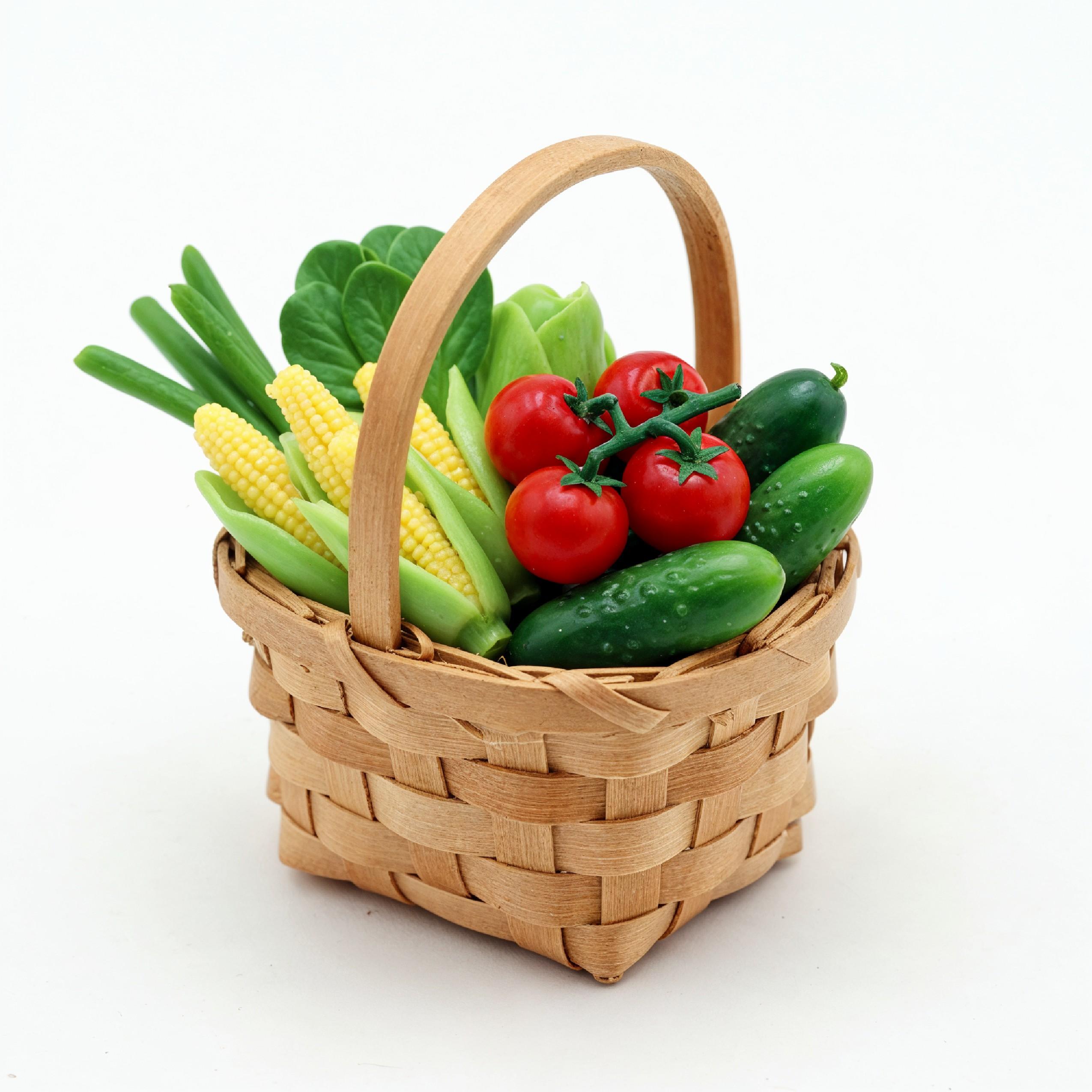 Miniature Vegetable Basket with Fresh Tomatoes, Corn and Cucumbers on White Background